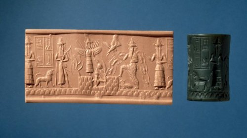 Illustration: Shamash the Sun-god setting (?) on the horizon. In his right he holds a tree (?), and in his left a ... with a serrated edge. Above the horizon is a goddess who holds in her left hand an ear of corn. On the right is a god who seems to be setting free a bird from his right hand. Round him is a river with fish in it, and behind him is an attendant god; under his foot is a young bull. To the right of the goddess stand a hunting god, with a bow and lasso, and a lion. From the seal-cylinder of Adda ..., in the British Museum. About 2500 B.C. [No. 89,115.]