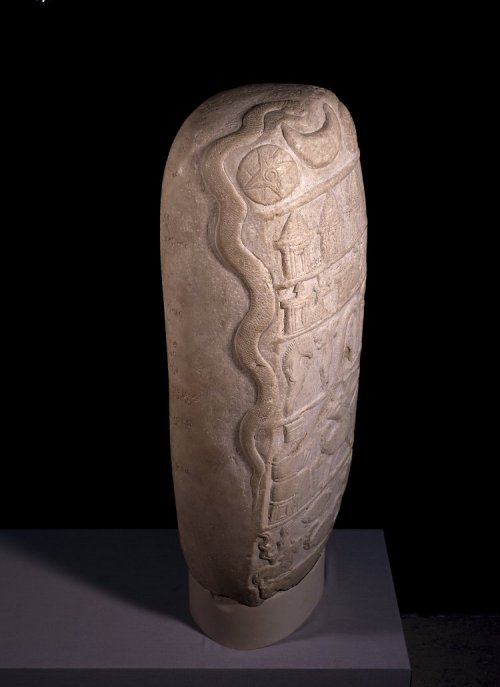 British Museum number 90858 Description 3/4: Right Limestone stela in the form of a boundary-stone: consisting of a block of calcareous limestone, shaped and prepared on four sides to take sculptures and inscriptions. It is now mounted on a stone plinth.  Faces B and C each bear a single column of inscription, the lines running the full width of the stone.  The top of the stone and Face D have been left blank, except for the serpent, which has been carved to the left of the emblems on Face A.  Inscribed with a Charter from the reign of Nebuchadnezzar I. 