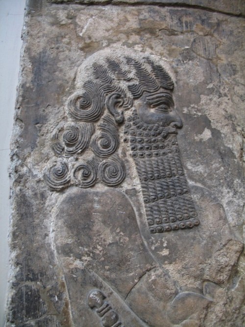 Lahmu is an Akkadian deity, the mythological first-born son of Apsu and Tiamat. With his sister Lahamu, they were the parents of Anshar and Kishar, the father of the sky and the mother of the earth, who begat the first gods. Lahmu is depicted as a snake, or as a bearded man with six hair curls. For the Sumerians, Lahmu was “the muddy one,” and this title was ever after given to the gatekeeper of the Abzu temple of Enki at Eridu. As gatekeeper, he is termed Lahmu the Hairy, or sometimes “the Hairy One.”  http://en.wikipedia.org/wiki/Lahmu