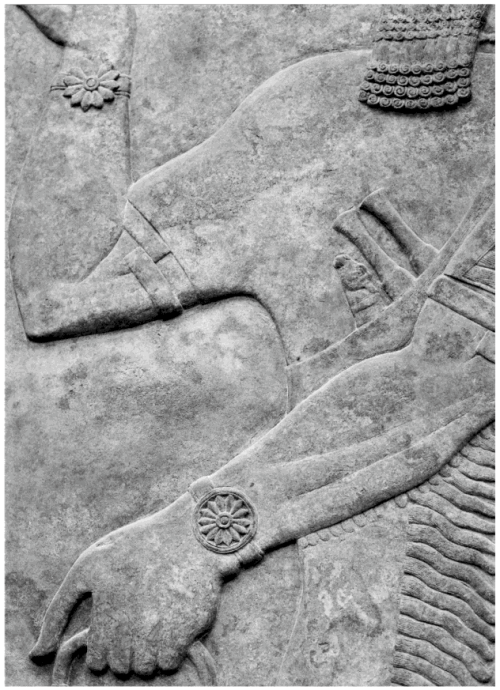 This detailed portrayal of the rosette bracelets is from Panel 12, Room G, Northwest Palace of Ashurnasirpal II at Nimrud. Armlets are visible at the elbow. <br /> This photograph is from Mehmet-Ali Atac, <em>The Mythology of Kingship in Neo-Assyrian Art</em>, Cambridge University Press, 2010, p. 110.<br /> British Museum ANE 124568.